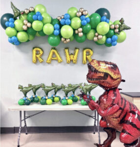 Dinosaur themed balloon garland and helium balloon by Caledon Balloons